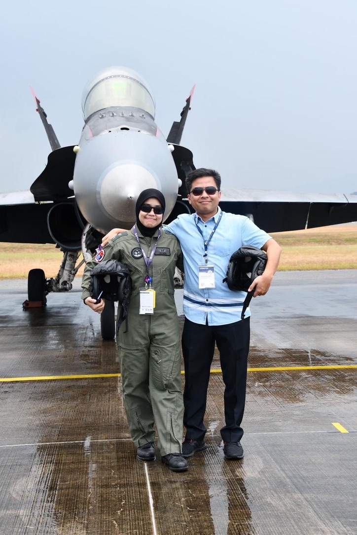Dr Amei Farina Abd and Capt Farik Iqbal standing in front of a jet